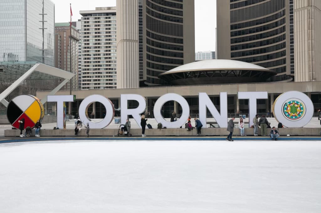 Me on my atto mobility scooter in front of Toronto sign